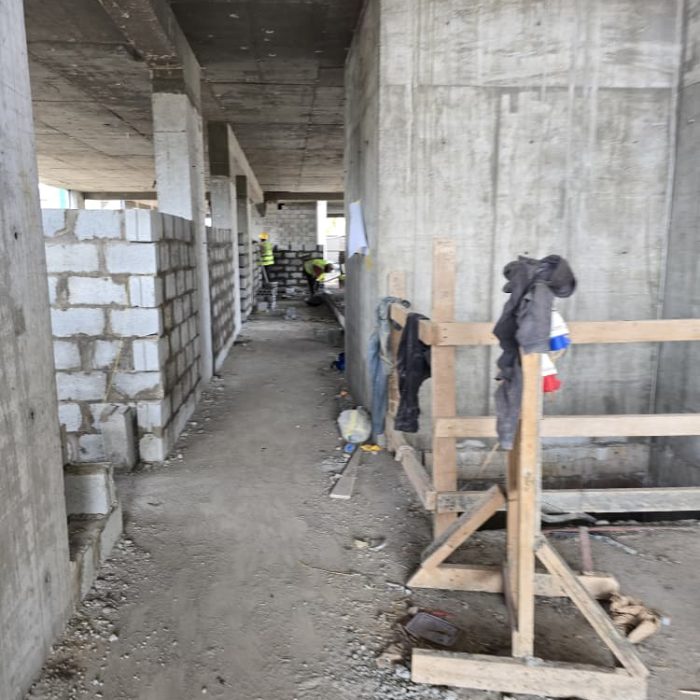 Structural wall framing and concrete block installation in progress for a new real estate development in Accra.