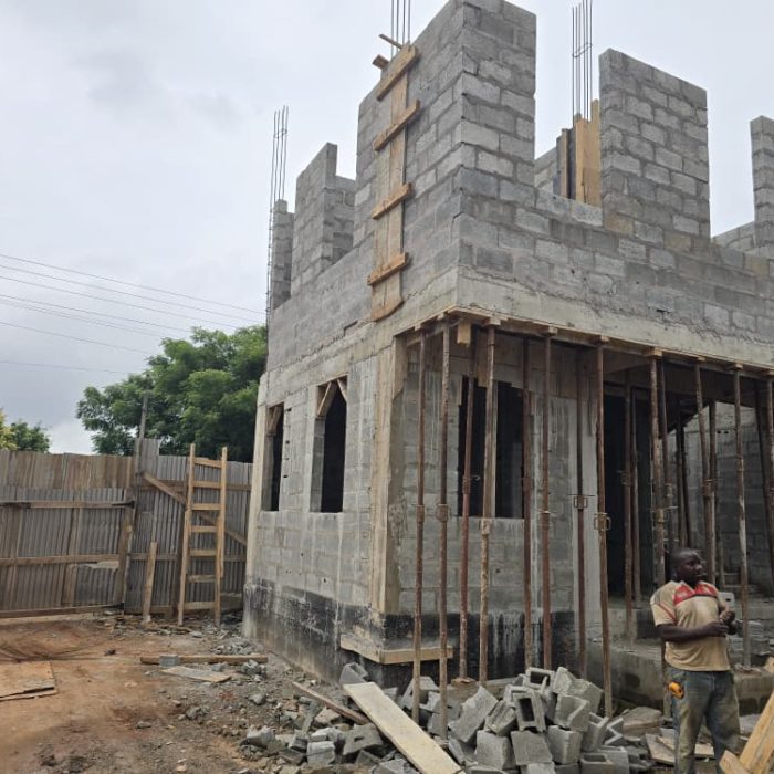 Structural wall framing and concrete block installation in progress for a new real estate development in Accra.