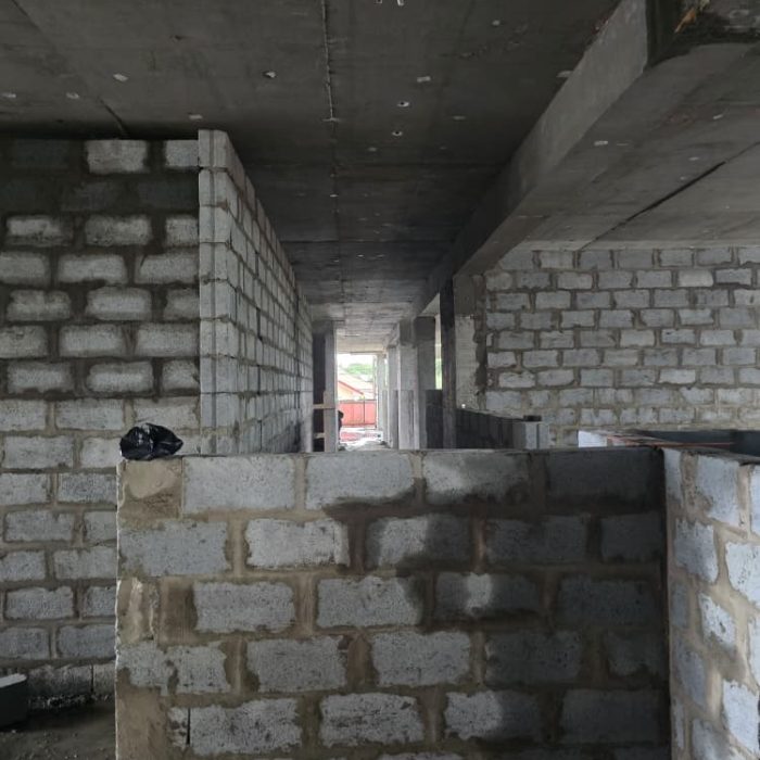 Detailed view of precise concrete blockwork and vertical alignment on a residential construction project in Accra.