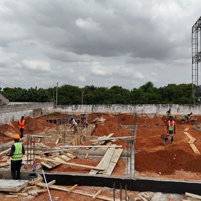 Progress update showing ground-floor blockwork walls rising at a multi-story building site in Abelemkpe