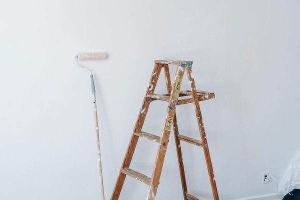 A minimalistic interior design scene with painting tools ready for a room renovation project.